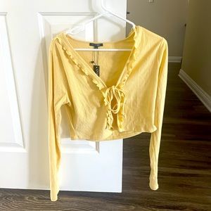 Yellow long sleeve crop top cardigan with ruffle detail and tie front